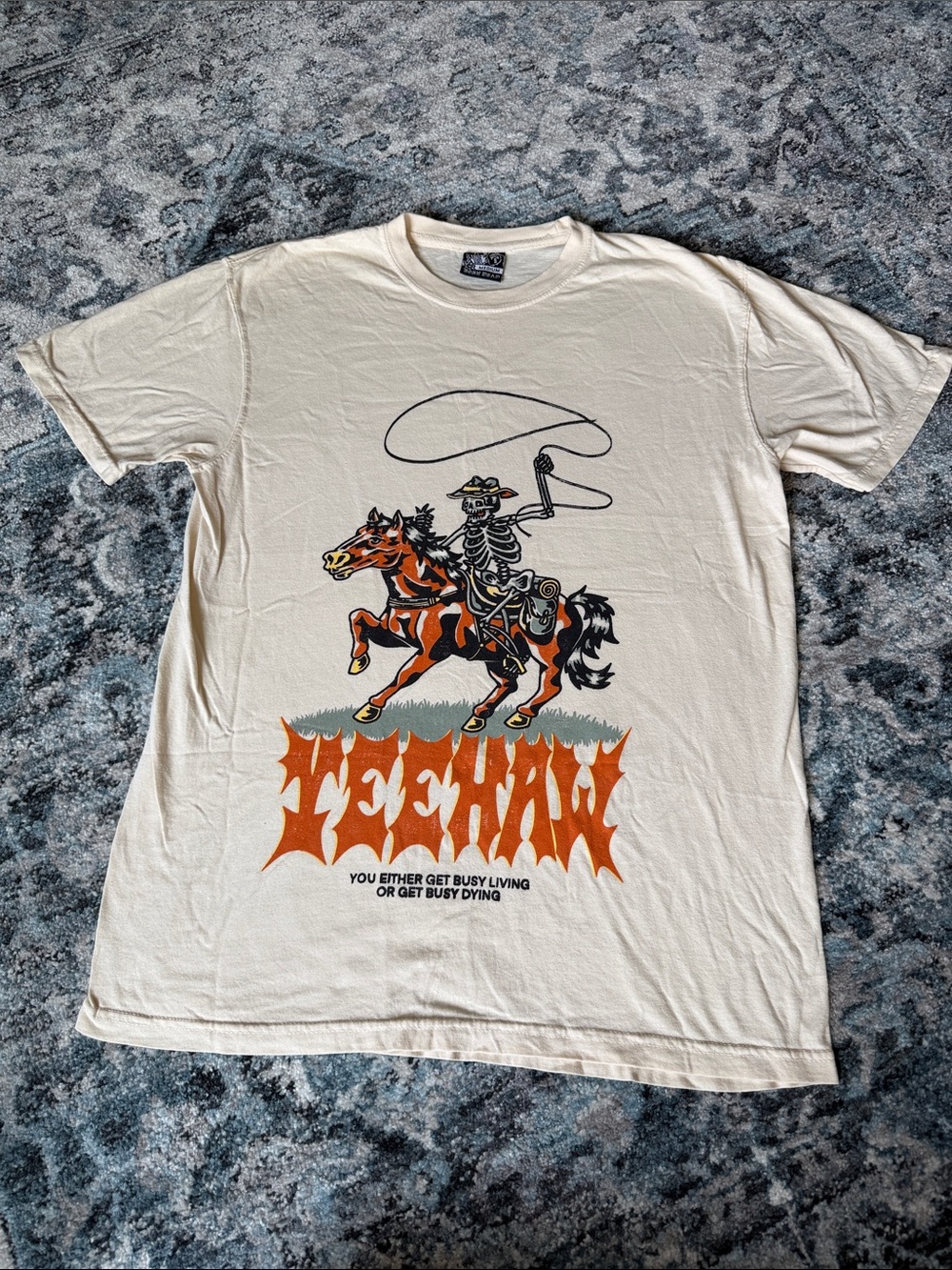 Cream Graphic Short-Sleeve Tee with Orange Cowboy Skeleton Motif
